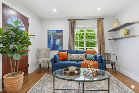 Bright, comfortable living room with AC and spacious seating—perfect for relaxing and gathering with your group.