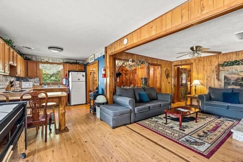 The open layout connects the living room and kitchen, making it easy for everyone to gather together. Whether cooking, relaxing, or chatting, this space keeps the whole group connected.