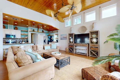 Living area with vaulted ceilings and 58" large smart cable TV with soundbar