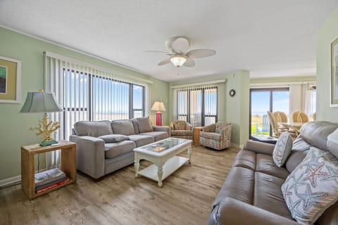 Relax in your spacious living room with plush seating and refreshing coastal colors that create the perfect beach getaway atmosphere.