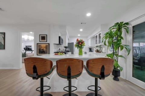 The large kitchen island with bar seating creates a perfect space for casual meals, morning coffee, or socializing while meals are prepared.