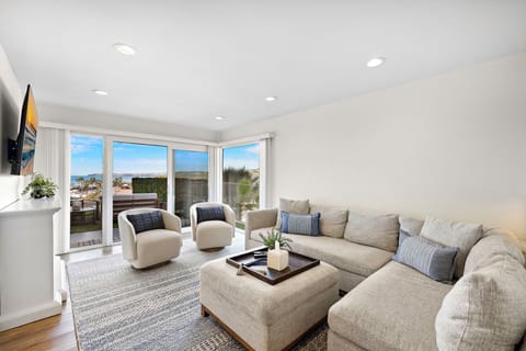 New listing from hosts with 4.98 star rating.  The living area has ocean views, comfortable seating, a cozy fireplace, Smart TV and lots of natural light pouring in from the private back yard.