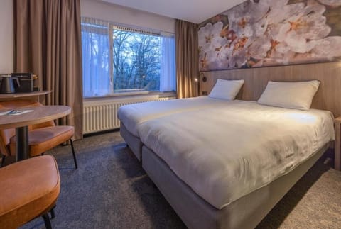 Sink into crisp twin beds beside serene woodland views.