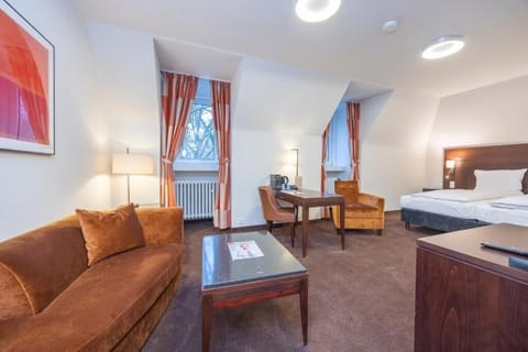 Settle in with a roomy layout, desk, and comfortable seating.