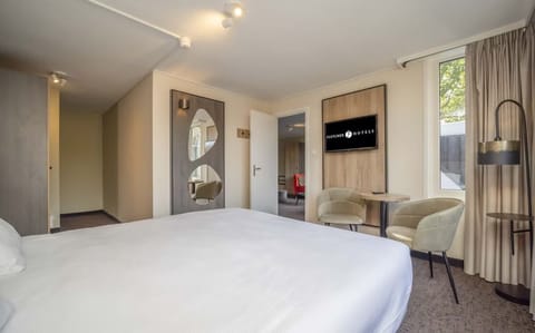Stretch out on crisp linens and enjoy a calm, modern room.