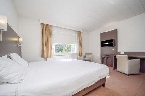Recharge in a clean, modern room with generous floor space.