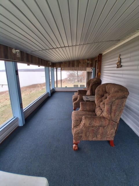 screened porch with recliner chairs