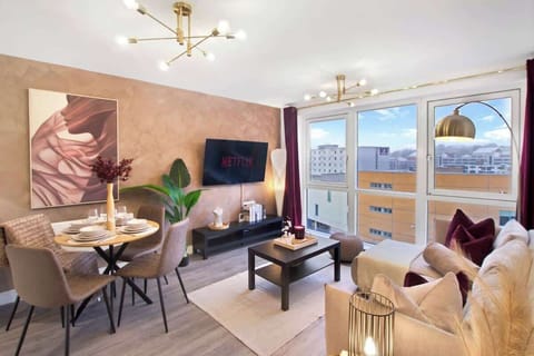 Beautifully designed living room with Smart TV, comfortable seating, and large windows creating a bright and relaxing space.
