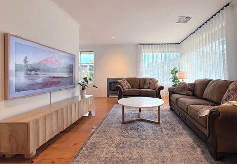 Front seecond living room comes with extremely large wall mounted flat screen TV
