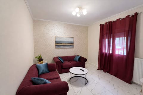 Spacious living area with comfortable sofas, elegant décor, and natural light from large windows.