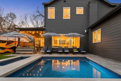 Luxury backyard oasis at Groove & Glam Retreat in Austin – private pool, chic lounge seating, and glowing patio lights for the ultimate upscale getaway.