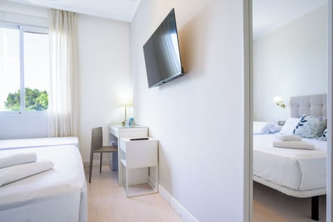 Standard Triple Room | Minibar, desk, laptop workspace, blackout drapes