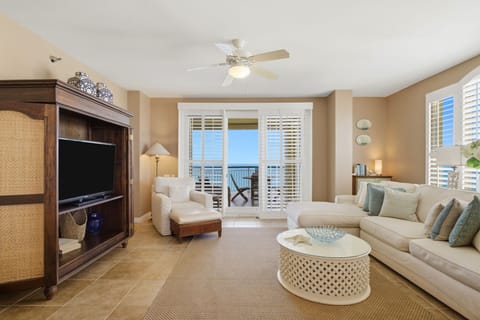 Beach Colony T PH1D- Sink into plush seating and unwind in your bright, beachy living room, where plantation shutters frame the sparkling sea and your private balcony beckons for morning coffee or sunset cocktails.