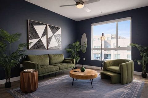Spacious living room featuring a cozy sofa, a full-size air mattress, and a 65" Smart TV with preloaded access to Netflix, Hulu, and Disney+, all set up for your enjoyment.