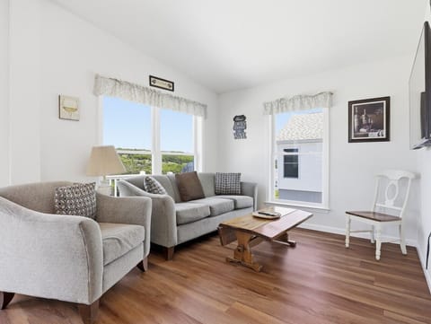 Living Room | Gray Sofa | Hardwood Floors & Scenic Views