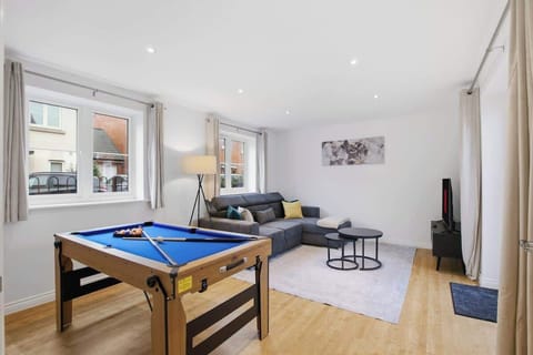 Games & Lounge Room: A spacious and comfortable living area featuring a pool table, cosy seating, and a Smart TV — perfect for relaxing, watching movies, or enjoying a friendly game.