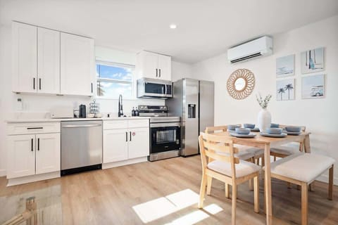 beautiful kitchen and living room area with lots of natural light and ocean views just right out the front door onto the balcony with outdoor seating.