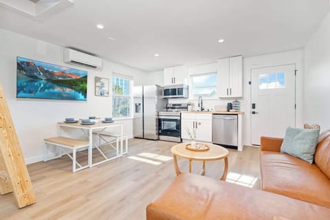 open, spacious well lit living room/dining room/kitchen area with views of the ocean to the east.