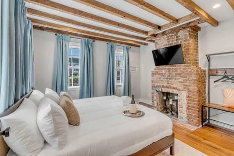 A grand primary retreat with a historic fireplace and elegant period details.