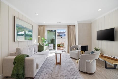 Light-filled living room with cozy seating, candle lite fireplace with remote, and sliding doors leading to a private patio — ideal for enjoying Napa Valley’s indoor-outdoor lifestyle.
