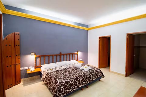 Unwind in a spacious bedroom with crisp linens and calm tones.