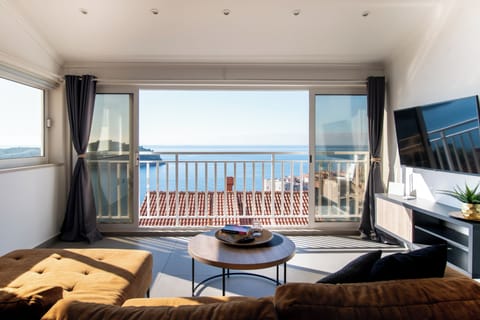 Apartment, Sea View | Living area | 80-cm Smart TV with cable channels