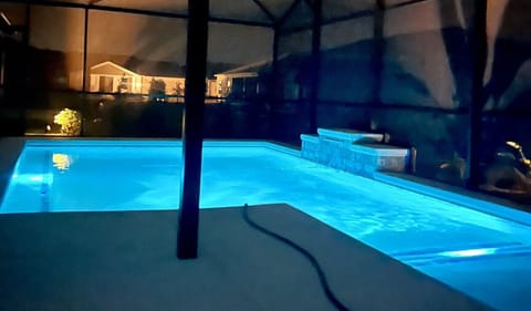 Midnight View of Private Screened-in Pool w/ Sunning Ledge & Chaise, Lounge Seating & Outdoor Dining