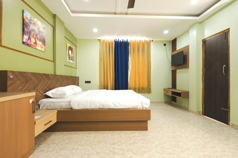 Deluxe Quadruple Room, City View | Desk, laptop workspace, free WiFi