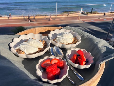 Breakfast on the balcony, enjoying the fresh sea air and stunning views.