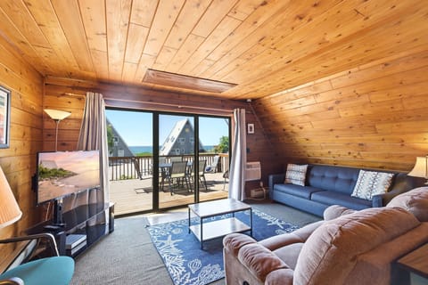 Chalet Om's living room opens to a wide deck with lake views.