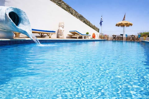 Inviting shared swimming pool with sun loungers