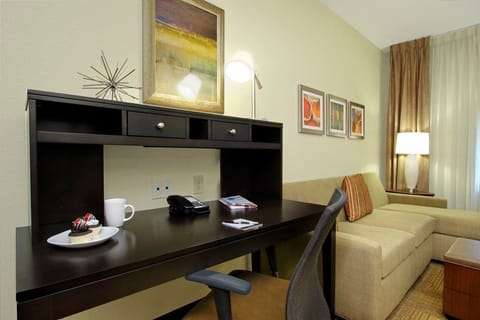 Settle in at your workspace with a view of cozy seating, ideal for relaxing or catching up on emails.