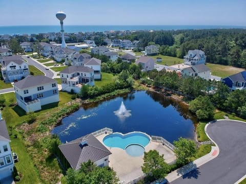Take a dip in the inviting community pool, surrounded by lush greenery and tranquil waters.