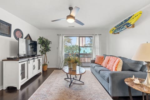 Relax in your bright living space with comfortable seating with balcony views