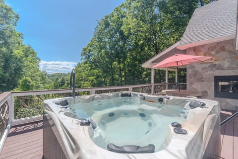 Private hot tub deck with forest views and cozy outdoor living