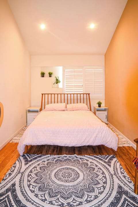 Bright bedroom with a double bed and shuttered window, the perfect spot to rest and wake up refreshed.