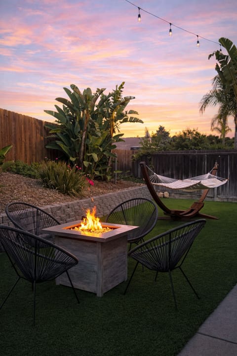 Sink into the hammock or gather around the fire pit in your private backyard oasis.