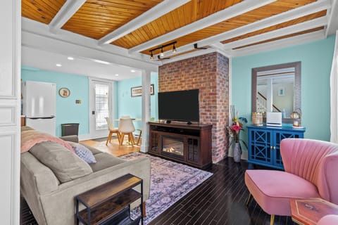 Bright living room with brick fireplace, Smart TV & cozy seating