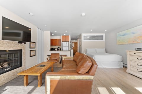 Relax in your open-concept studio with rich leather seating, cozy fireplace, full kitchen, and comfortable sleeping area perfectly designed for your getaway.