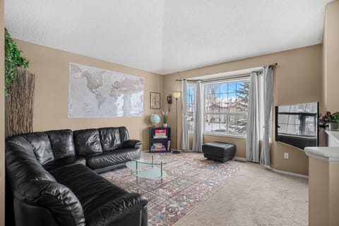 Bright living room with large sectional and fast Wi-Fi for remote work or relaxing nights.