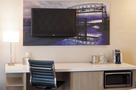 Premium bedding, desk, laptop workspace, blackout drapes