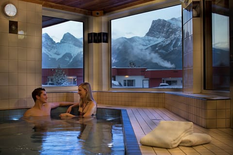 Relax in the hot tub with the Canmore mountains filling the windows after a day on the slopes