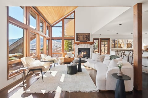 Spacious and light-filled living/dining/kitchen on the second floor of this gorgeous multi-tiered home. Enjoy views looking down at the Brush Creek Valley and the Snowmass Club.