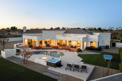 Relax in a desert retreat with pool, hot tub, and glowing fire feature.