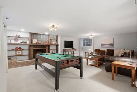 Spacious game room with pool table and cozy lounge seating