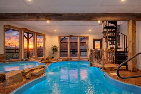 Private indoor pool with a hot tub, waterfall features, and space to unwind year-round.
