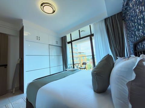 Apartment, Balcony, City View | Desk, laptop workspace, blackout drapes, iron/ironing board