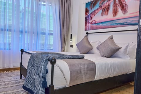 Apartment, City View | Desk, laptop workspace, blackout drapes, iron/ironing board