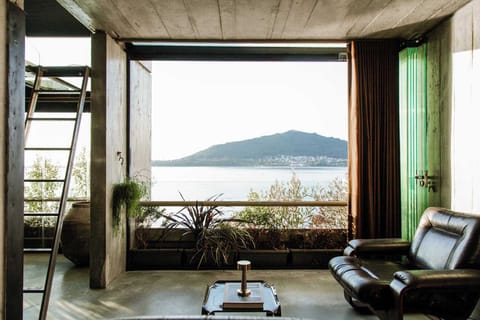 Panoramic waterfront lounge view framed by large picture windows facing the Minho River.