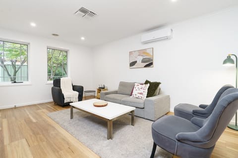 Relax in this spacious living area, filled with natural light and cosy seating for everyone.